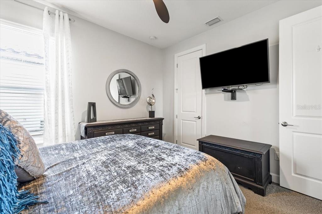 4760 Crestpoint Way Palmetto, FL 34221 - Photo 18 of 44 a bedroom with a bed and a flat screen tv