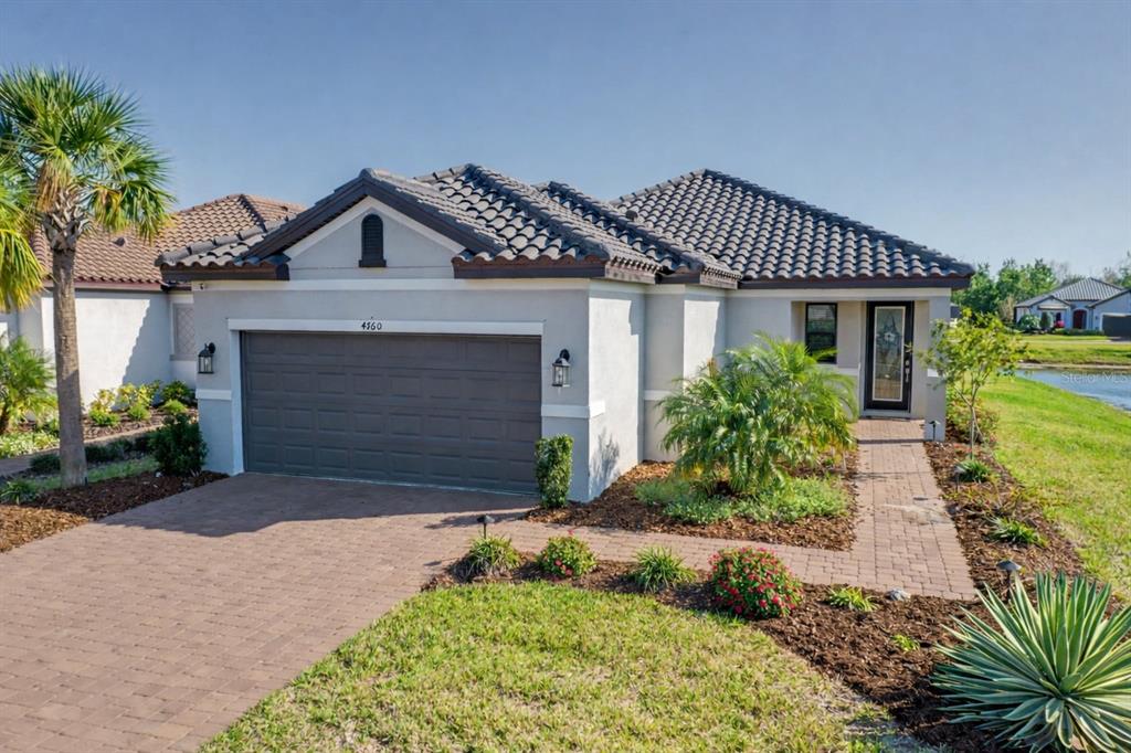 4760 Crestpoint Way Palmetto, FL 34221 - Photo 2 of 44 a front view of a house with a yard and garage