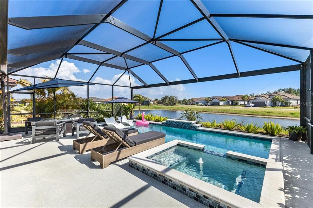 4760 Crestpoint Way Palmetto, FL 34221 - Photo 26 of 44 a view of a patio with a table and chairs under an umbrella