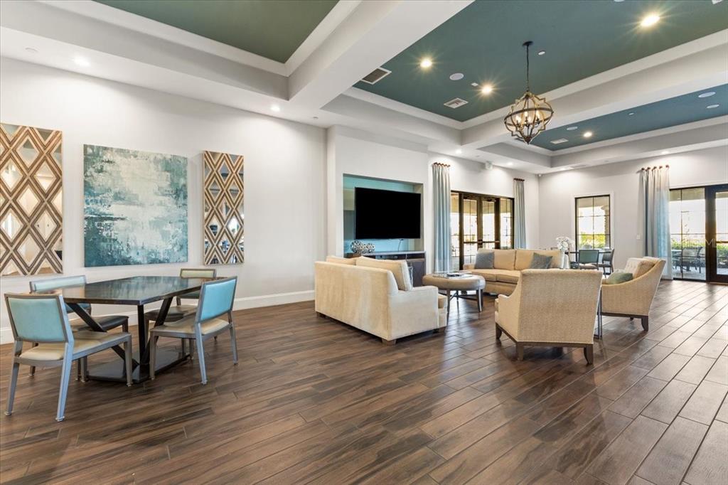 4760 Crestpoint Way Palmetto, FL 34221 - Photo 35 of 44 a dining room with wooden floor and large windows