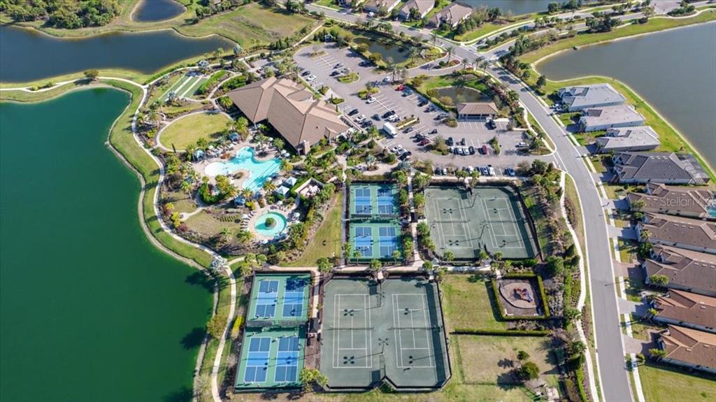 4760 Crestpoint Way Palmetto, FL 34221 - Photo 39 of 44 an aerial view of a residential apartment building with a yard and parking spaces