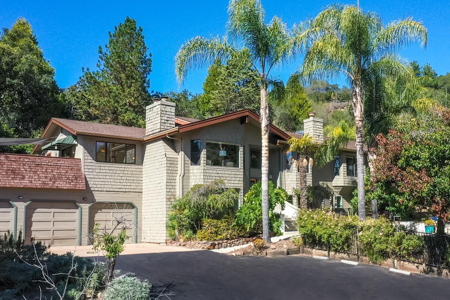 a front view of a house with a garden