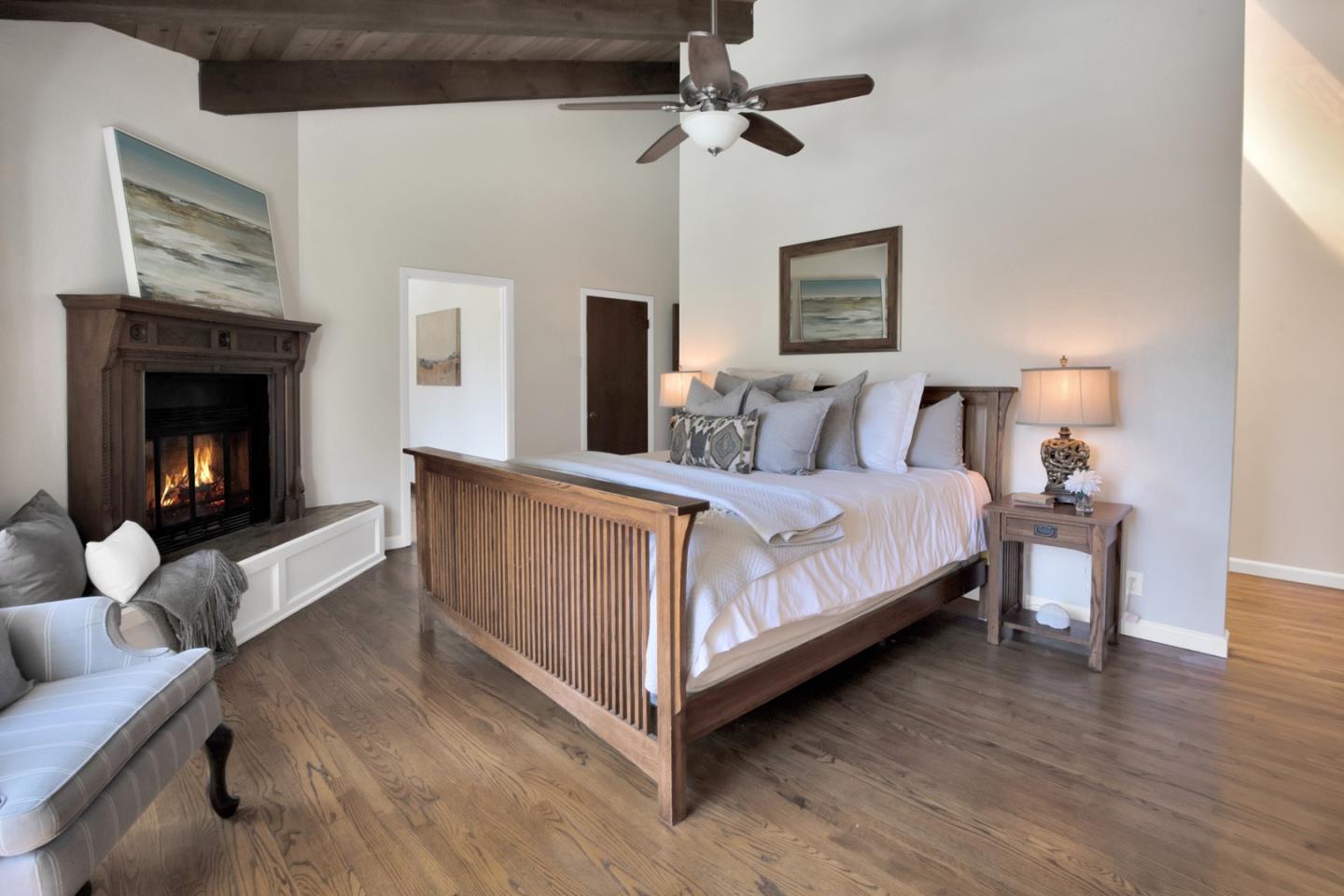 560 Hidden Valley Road Soquel, CA 95073 - Photo 24 of 59 a bedroom with a bed and a fireplace