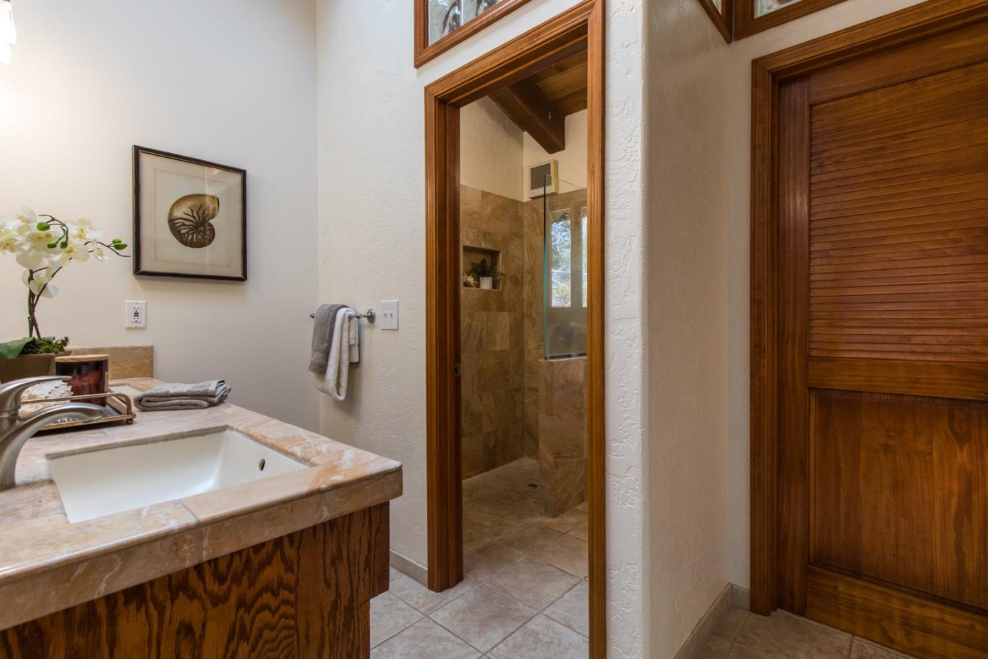 560 Hidden Valley Road Soquel, CA 95073 - Photo 29 of 59 a bathroom with a sink and a mirror