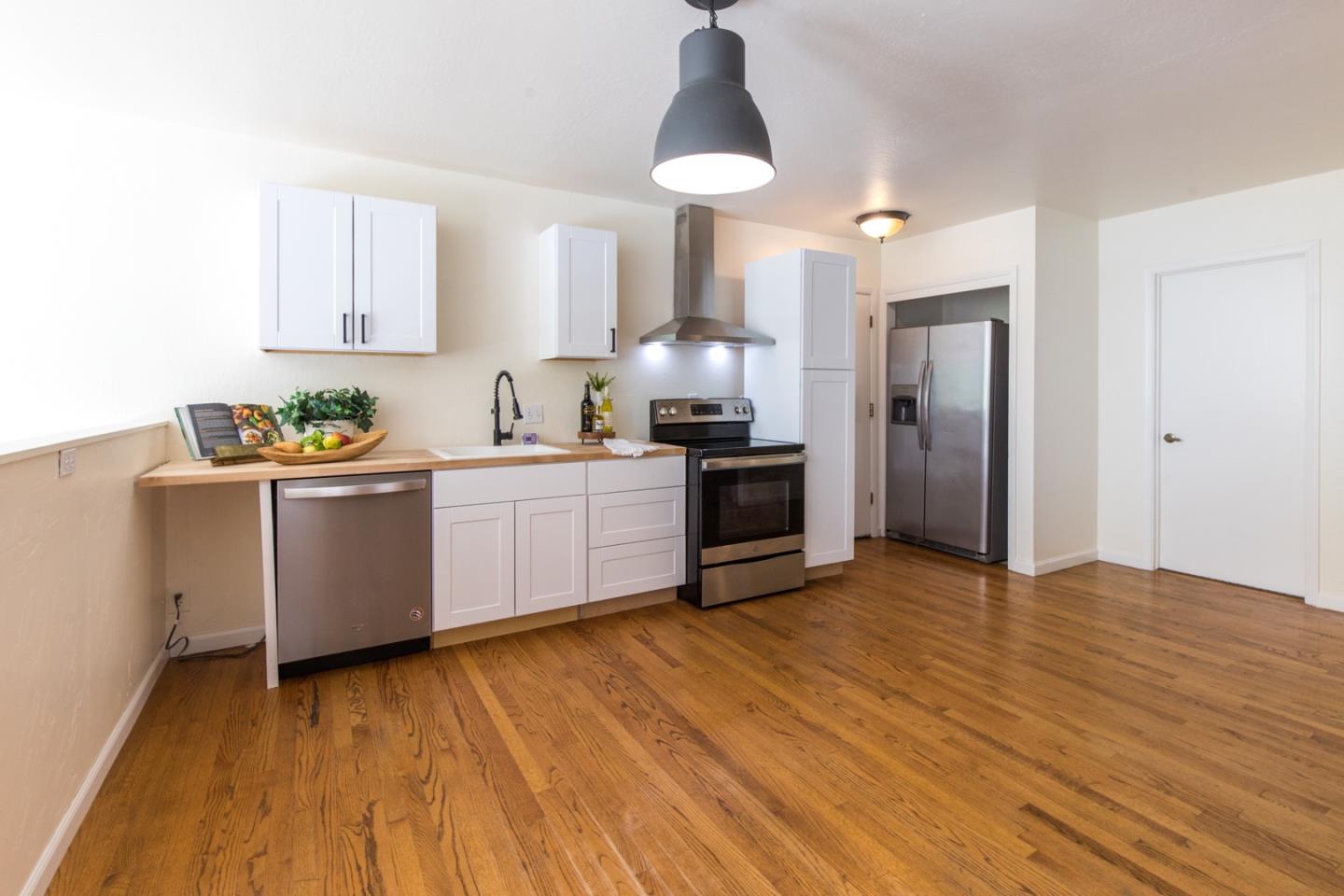 560 Hidden Valley Road Soquel, CA 95073 - Photo 36 of 59 a kitchen with stainless steel appliances a sink cabinets and wooden floor