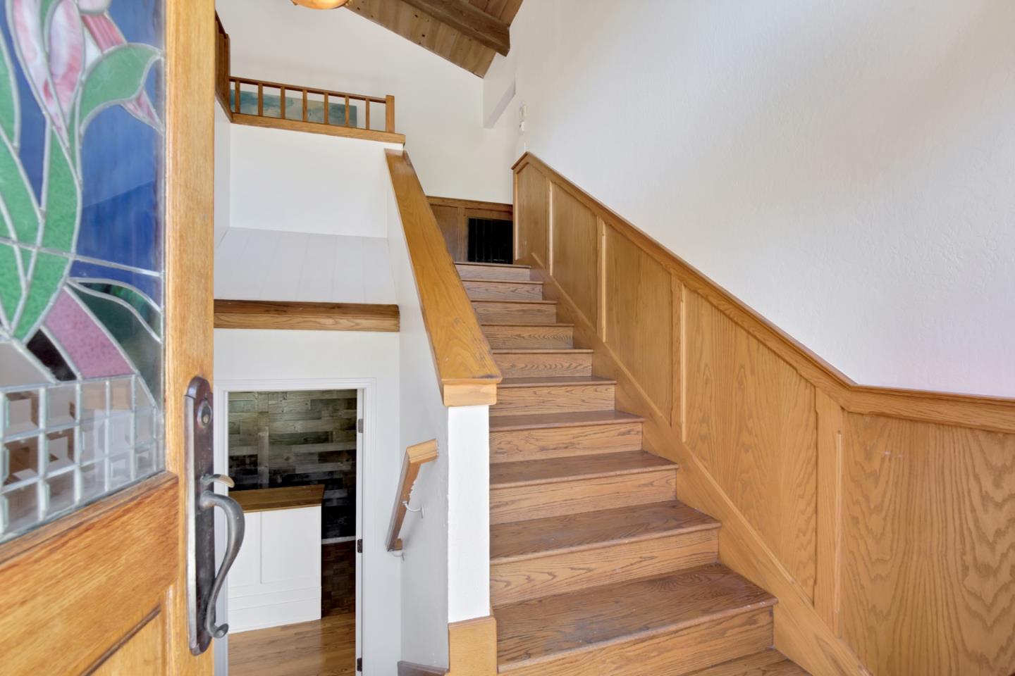 560 Hidden Valley Road Soquel, CA 95073 - Photo 9 of 59 a view of staircase with lots of frames on wall and a window