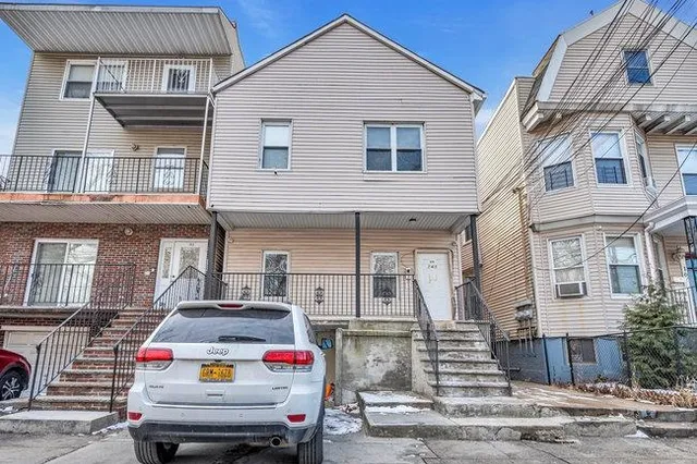 a white house covered with tall buildings