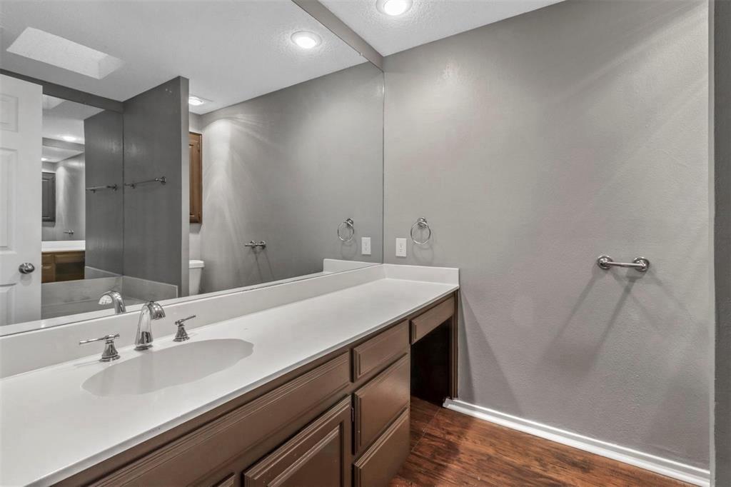 814 Custer Street Arlington, TX 76014 - Photo 11 of 17 a bathroom with a sink and a mirror