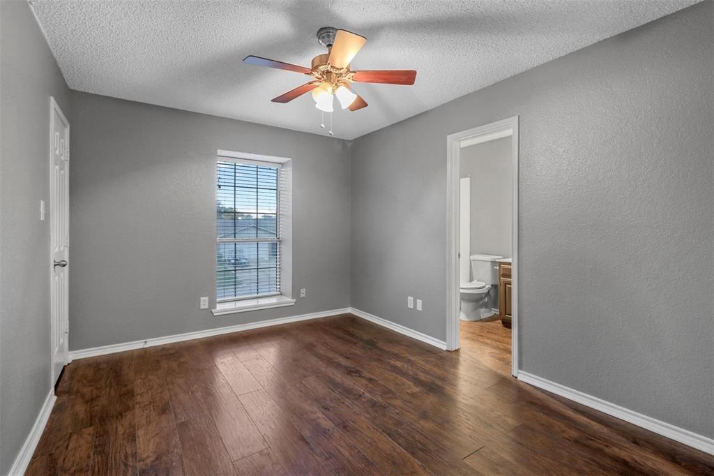 814 Custer Street Arlington, TX 76014 - Photo 12 of 17 an empty room with wooden floor and a window
