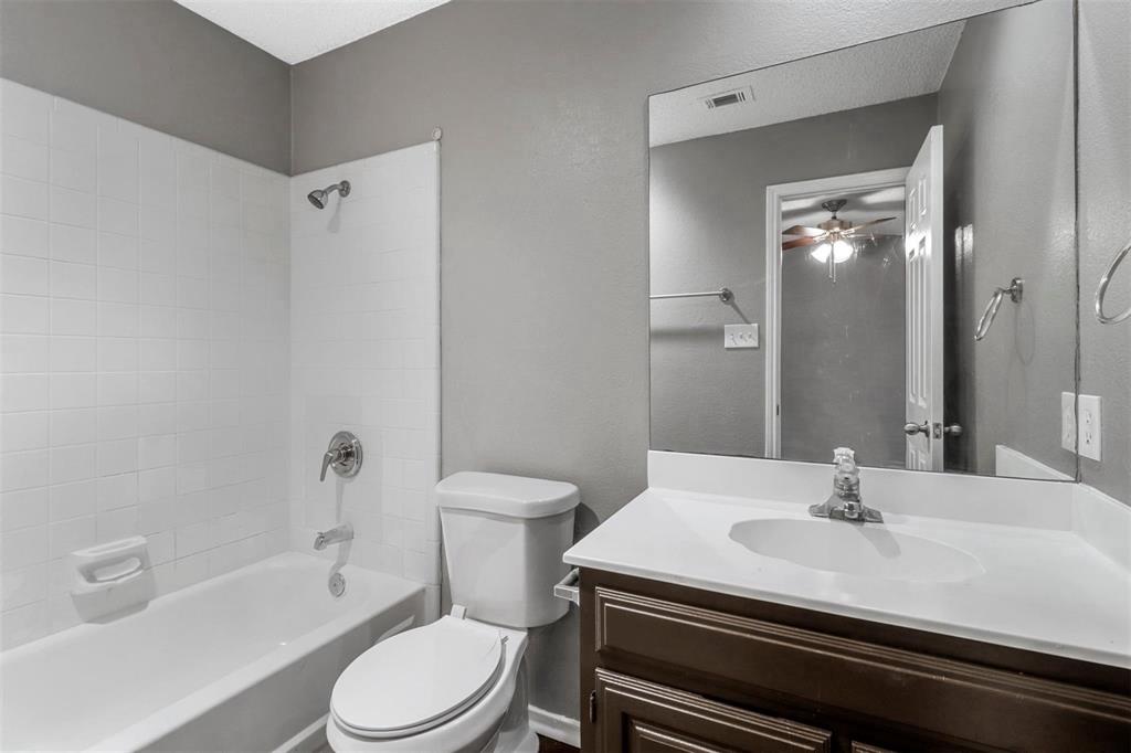 814 Custer Street Arlington, TX 76014 - Photo 13 of 17 a bathroom with a sink toilet a mirror and shower