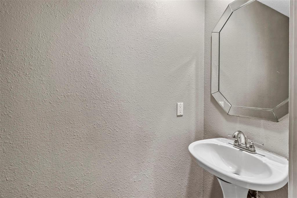814 Custer Street Arlington, TX 76014 - Photo 14 of 17 a bathroom with a sink and a mirror