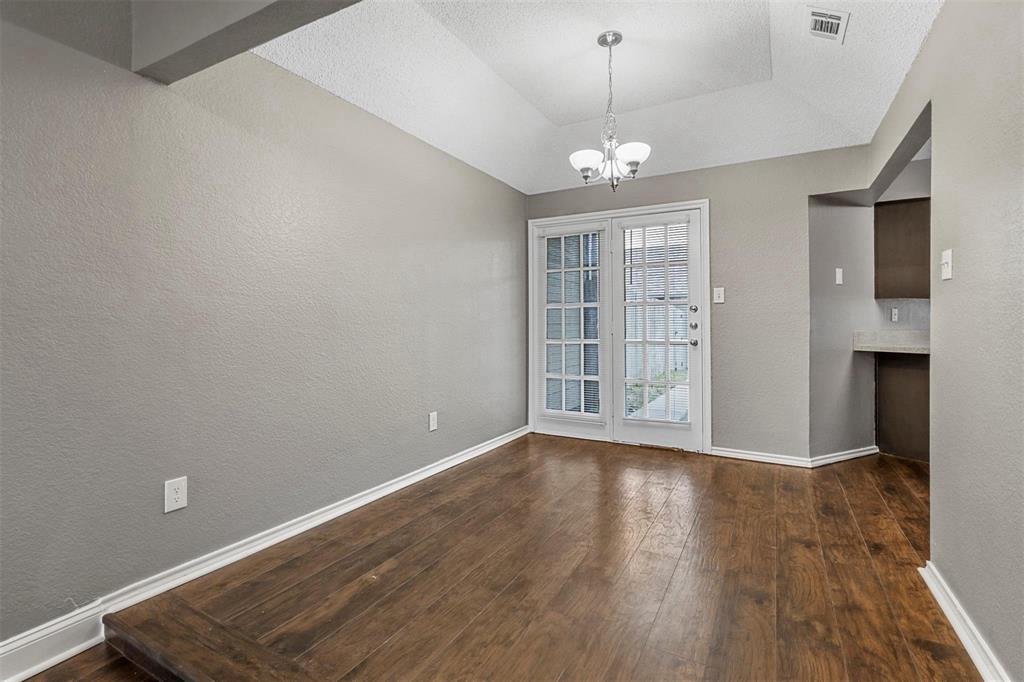 814 Custer Street Arlington, TX 76014 - Photo 4 of 17 a view of an empty room with a window and wooden floor