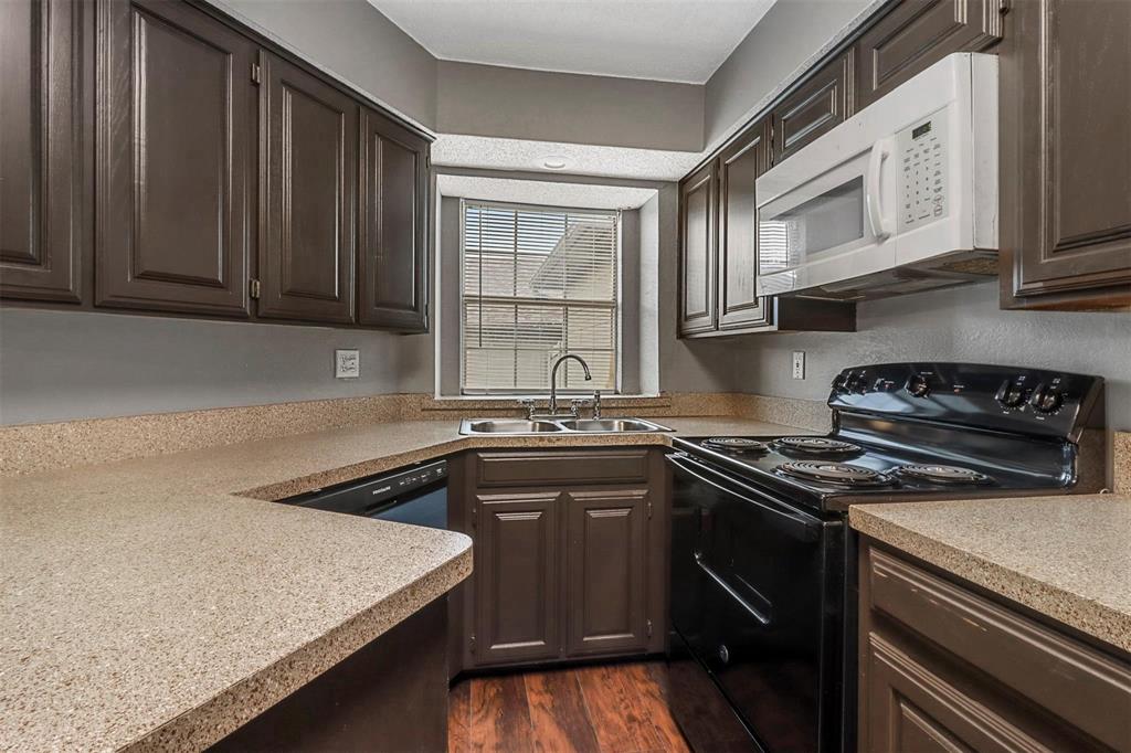 814 Custer Street Arlington, TX 76014 - Photo 6 of 17 a kitchen with stainless steel appliances granite countertop a sink stove and cabinets