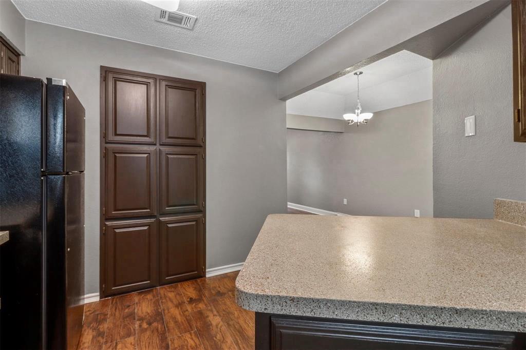 814 Custer Street Arlington, TX 76014 - Photo 7 of 17 a bathroom with a refrigerator and a sink
