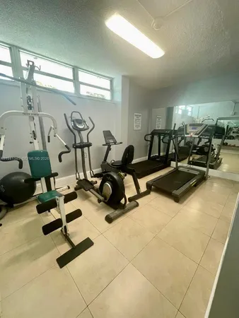 a room with gym equipment and a view of living room