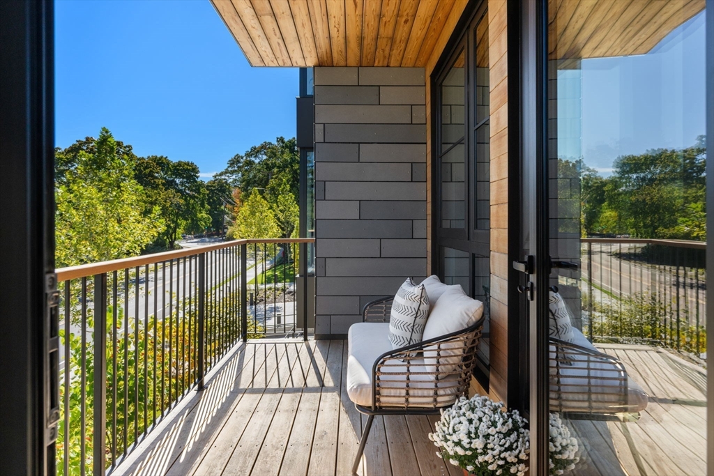 100 Linden Street, Unit 106 Wellesley, MA 02482 - Photo 12 of 28 a view of balcony with wooden floor