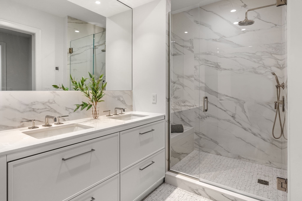 100 Linden Street, Unit 106 Wellesley, MA 02482 - Photo 9 of 28 a bathroom with a granite countertop sink a mirror and shower