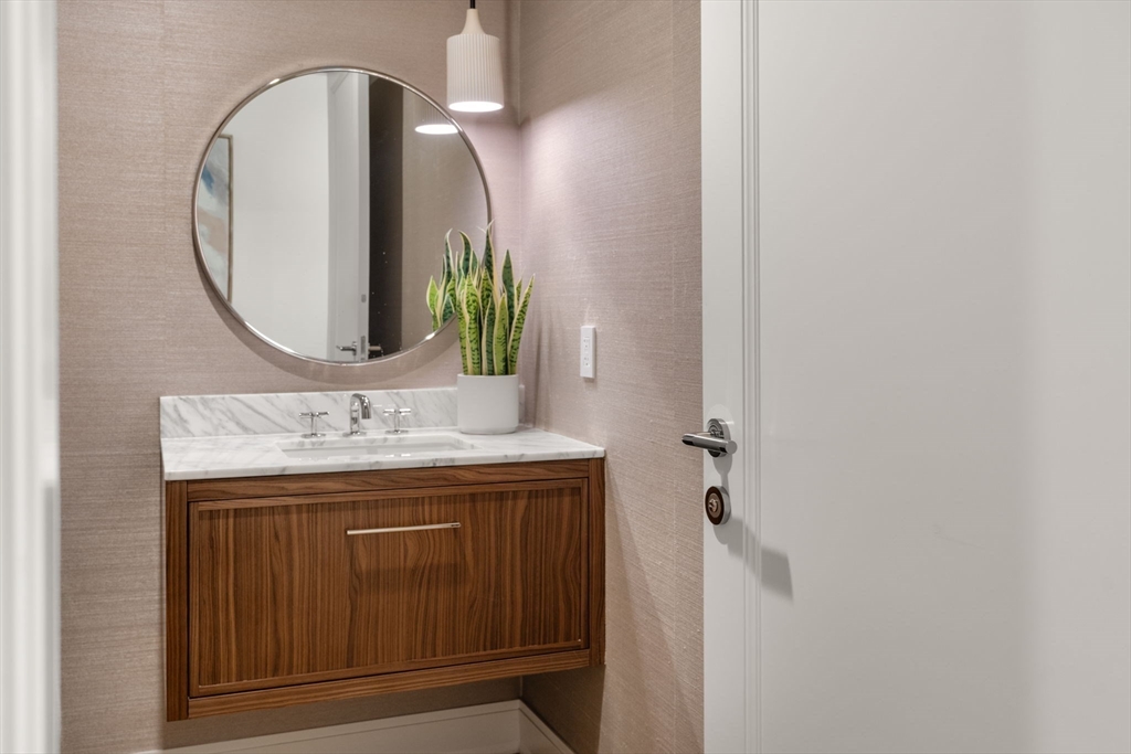 100 Linden Street, Unit 106 Wellesley, MA 02482 - Photo 10 of 28 a bathroom with a sink and a mirror