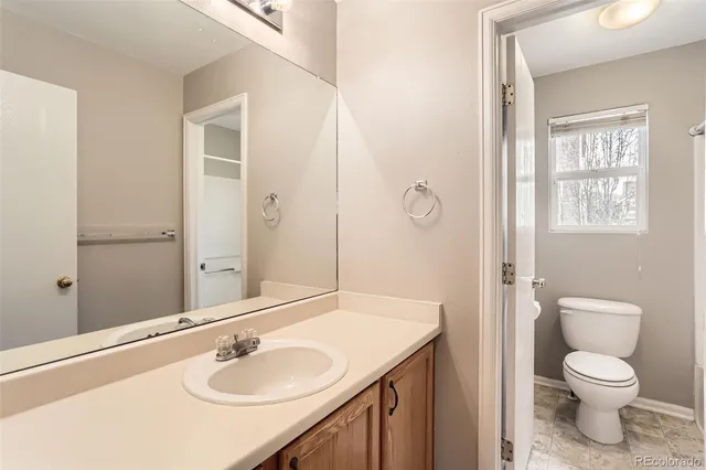 a view of a house with a small yard and wooden fence