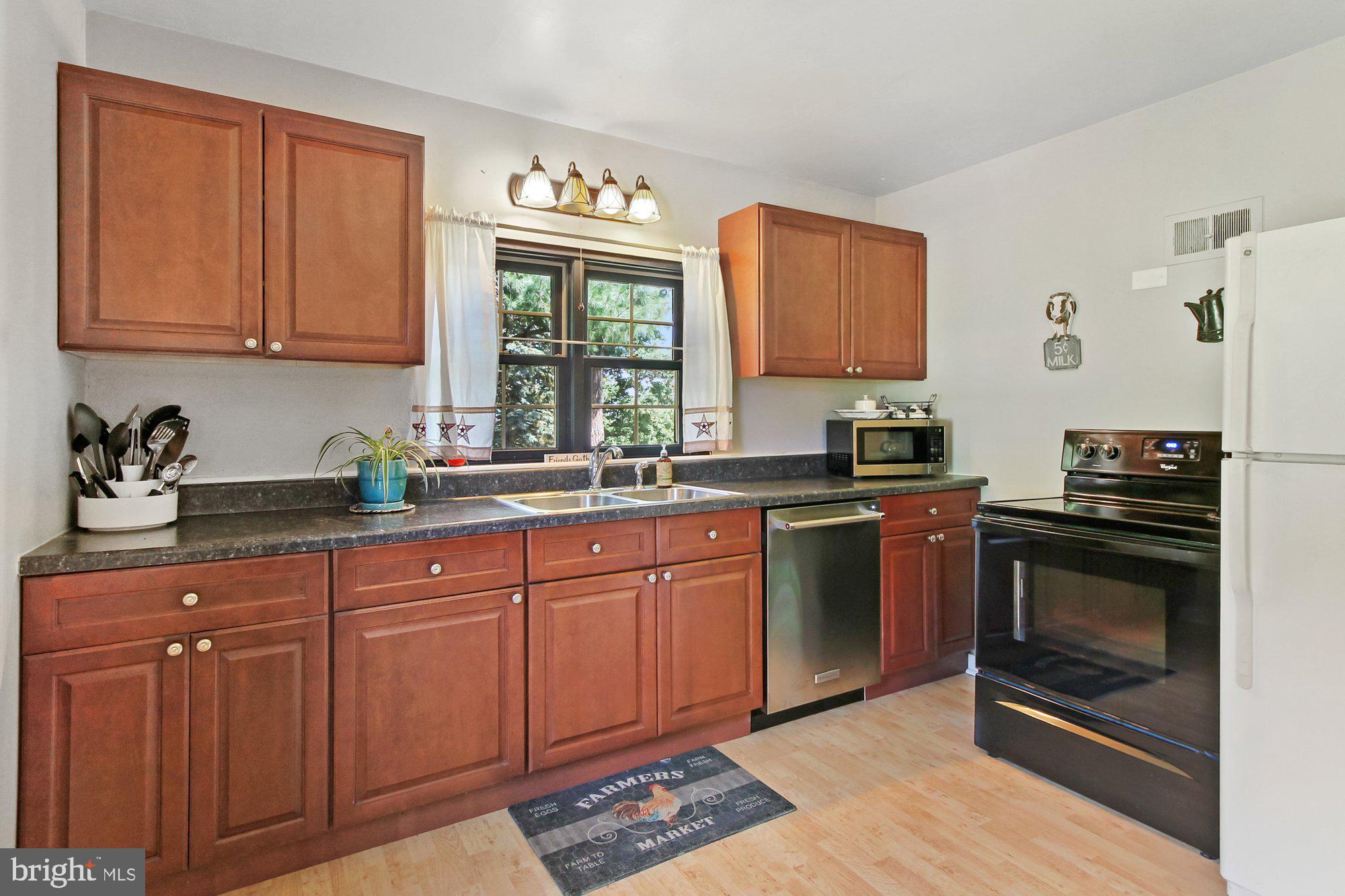 528 Hain Road Sinking Spring, PA 19608 - Photo 9 of 28 a kitchen with stainless steel appliances granite countertop a stove a sink and a microwave