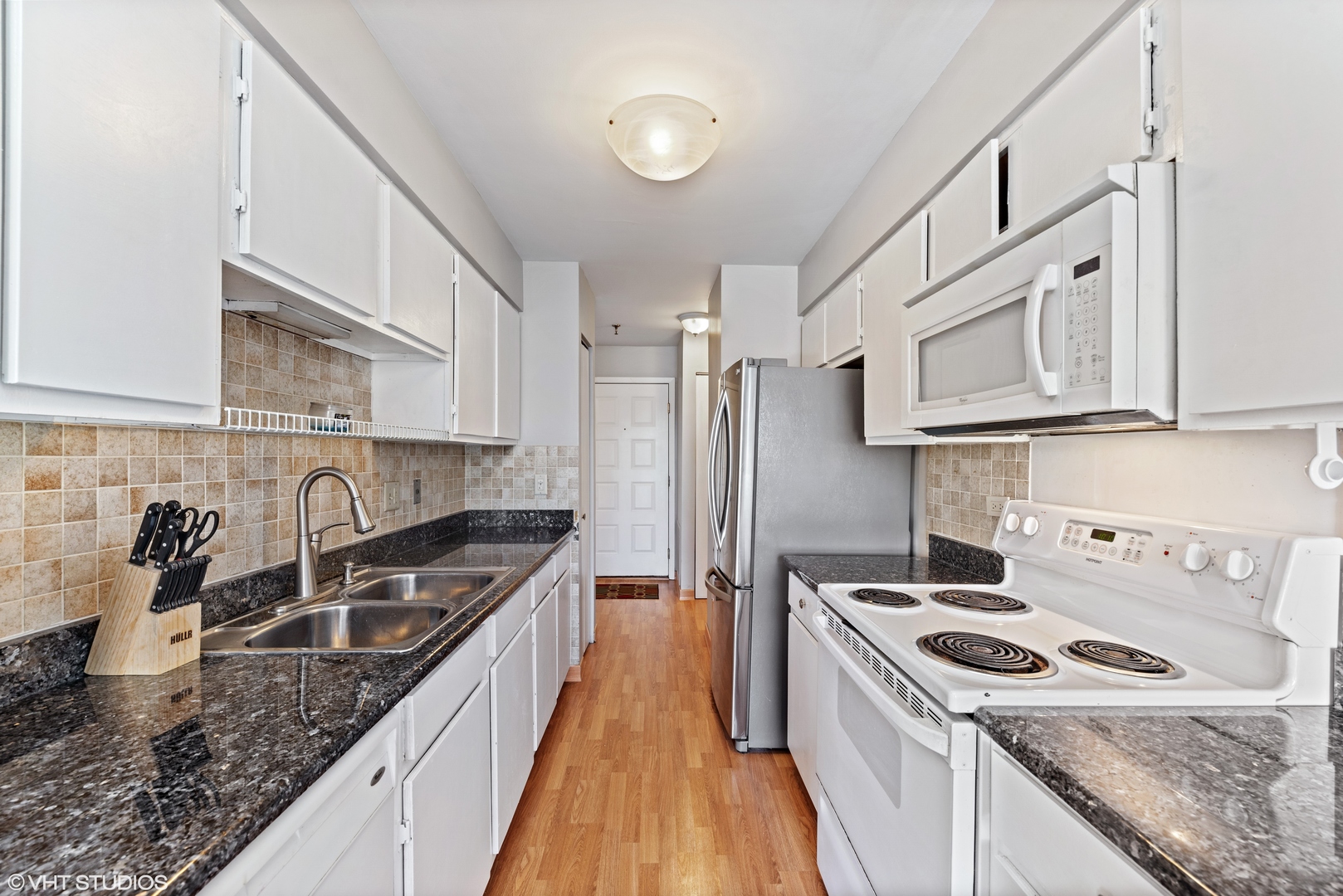 1400 North Elmhurst Road, Unit 203 Mount Prospect, IL 60056 - Photo 3 of 13 a kitchen with stainless steel appliances granite countertop a sink stove oven and refrigerator
