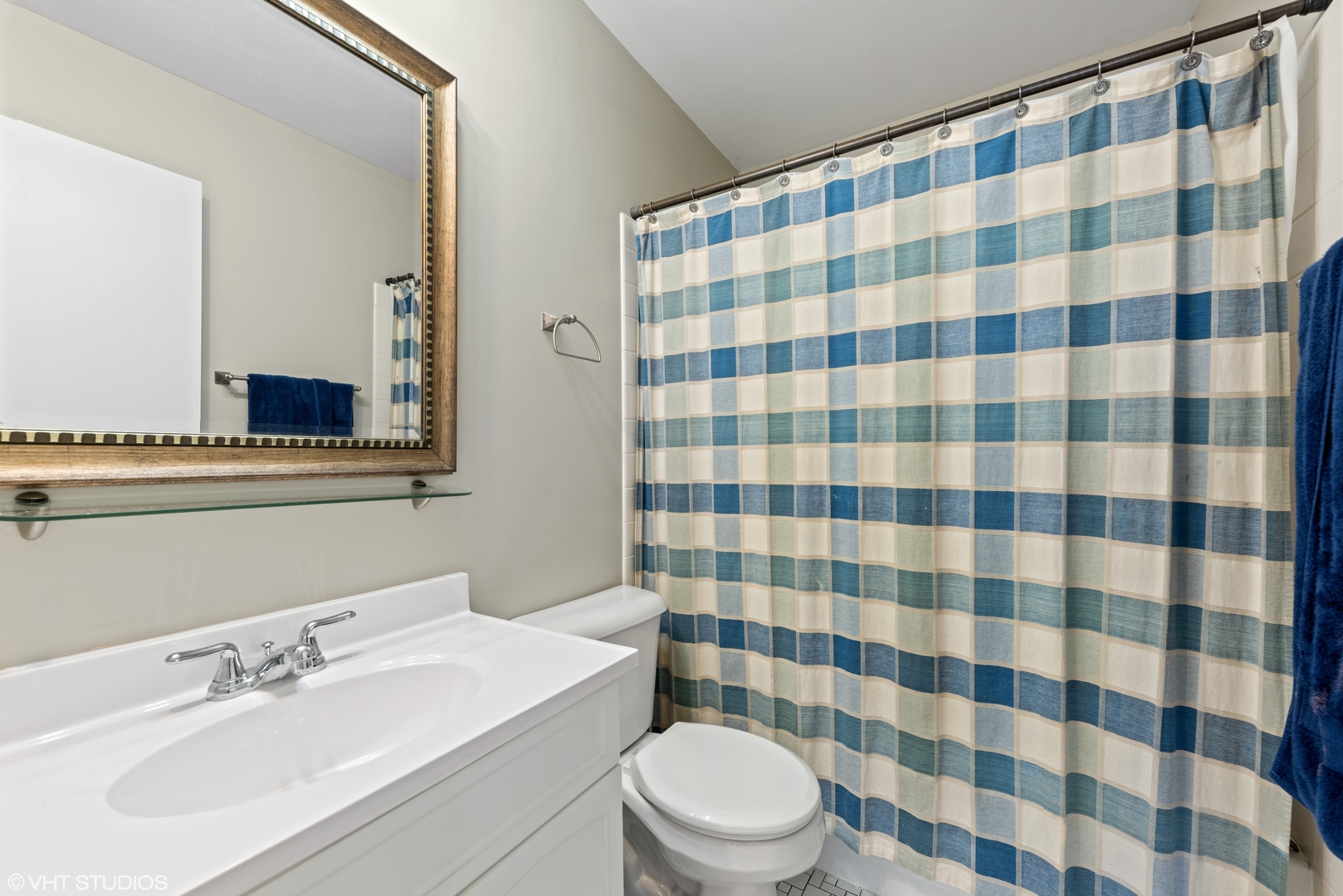 1400 North Elmhurst Road, Unit 203 Mount Prospect, IL 60056 - Photo 7 of 13 a bathroom with a sink a toilet a mirror and shower curtain