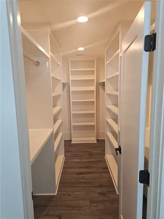 a spacious bedroom with a bed and a couch