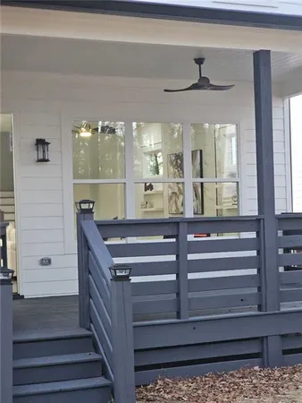 a view of entryway kitchen and hall with wooden floor