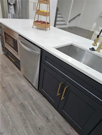 a large kitchen with kitchen island a sink table and chairs