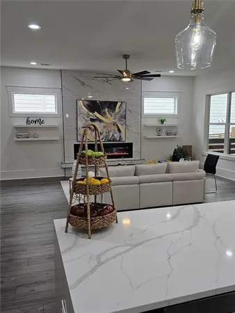 a living room with furniture and a kitchen view