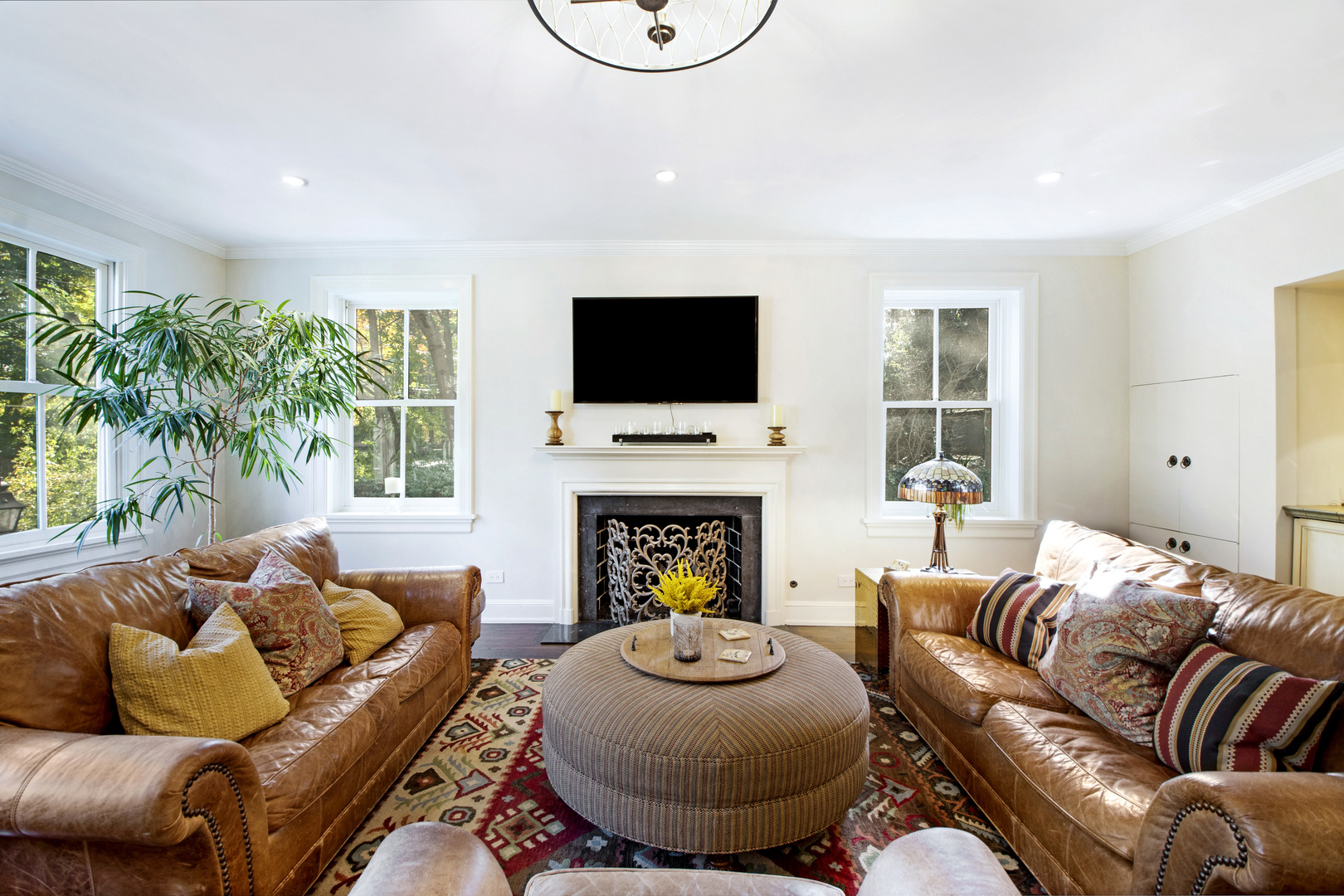 1380 Elm Tree Road Lake Forest, IL 60045 - Photo 16 of 43 a living room with furniture a fireplace and a flat screen tv