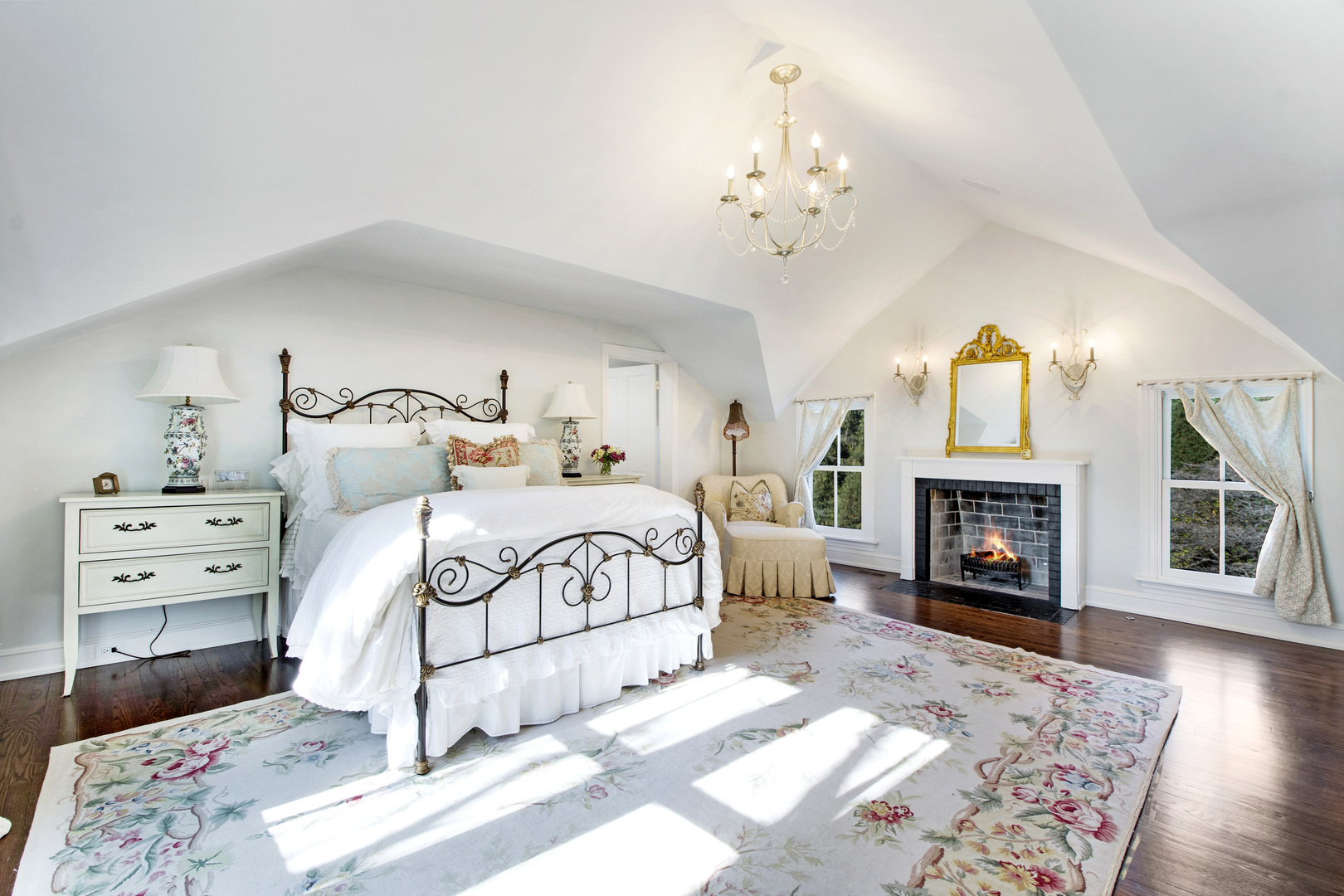 1380 Elm Tree Road Lake Forest, IL 60045 - Photo 19 of 43 a bedroom with a bed and a fireplace with chair