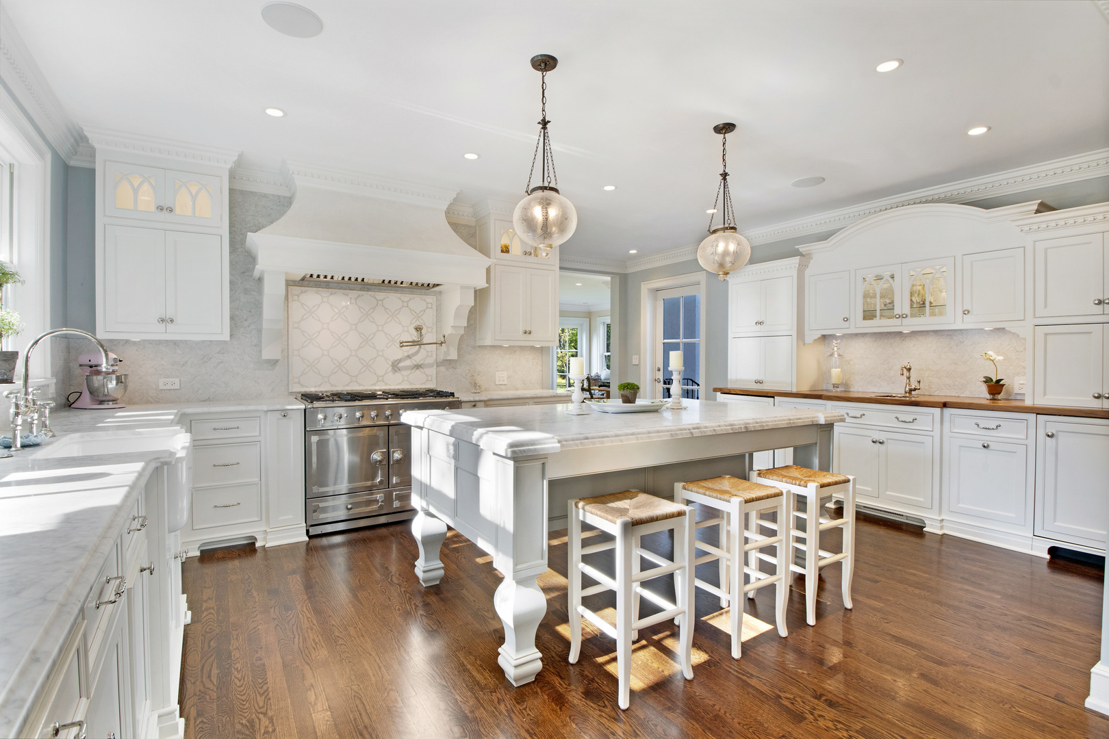 1380 Elm Tree Road Lake Forest, IL 60045 - Photo 8 of 43 a large kitchen with white cabinets and wooden floor