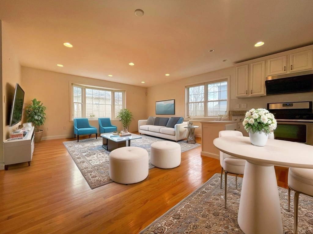 12 Naviens Lane, Unit 1 Waltham, MA 02453 - Photo 1 of 12 a living room with furniture a window and a flat screen tv