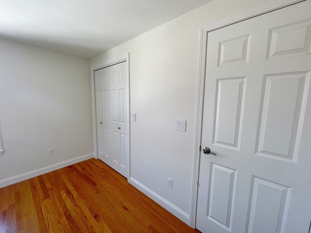 12 Naviens Lane, Unit 1 Waltham, MA 02453 - Photo 11 of 12 a view of a room with wooden floor and bathroom