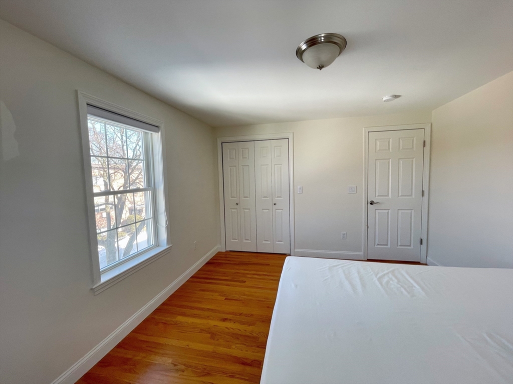 12 Naviens Lane, Unit 1 Waltham, MA 02453 - Photo 12 of 12 a bedroom with bed and window