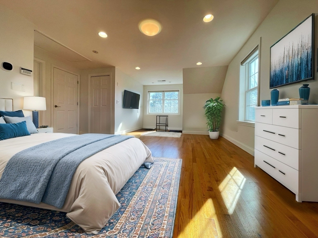 12 Naviens Lane, Unit 1 Waltham, MA 02453 - Photo 2 of 12 a spacious bedroom with a large bed and a dresser