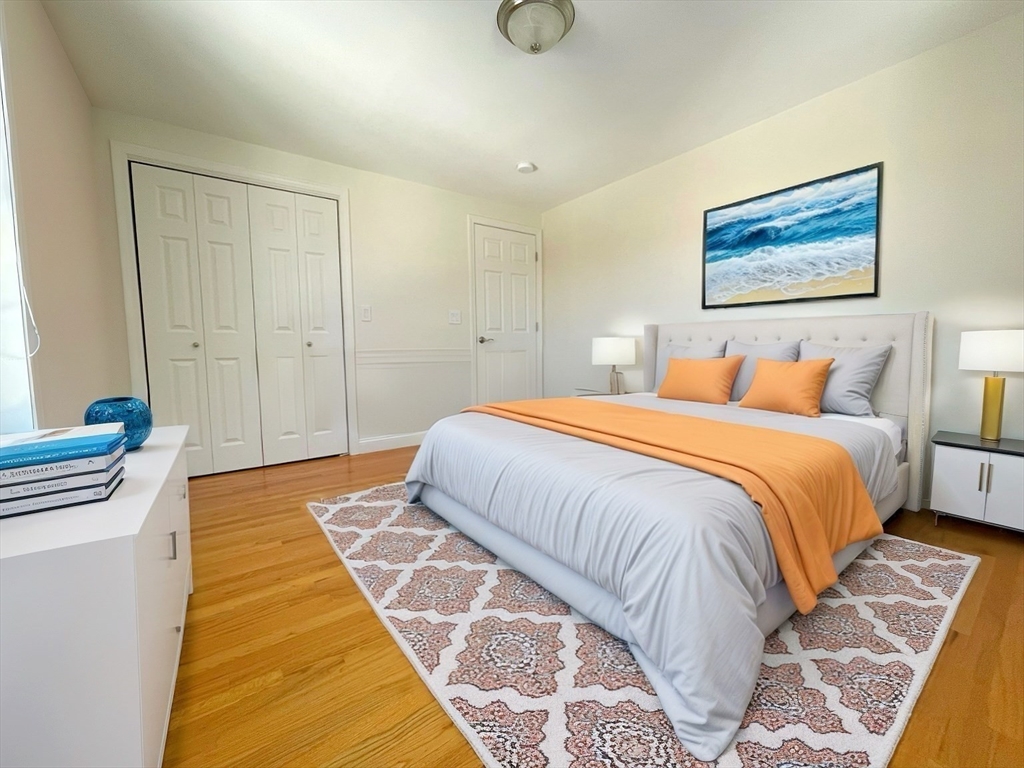 12 Naviens Lane, Unit 1 Waltham, MA 02453 - Photo 3 of 12 a bedroom with a bed and a painting on the wall