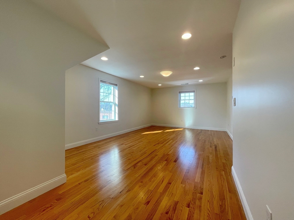 12 Naviens Lane, Unit 1 Waltham, MA 02453 - Photo 4 of 12 a view of empty room with wooden floor
