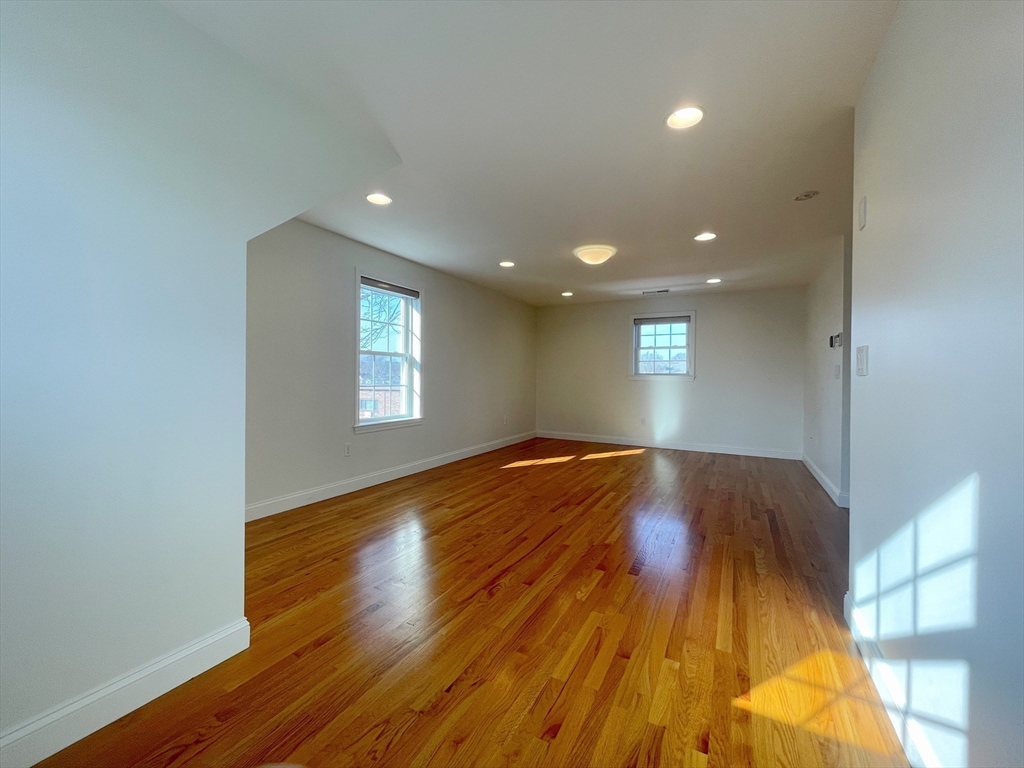 12 Naviens Lane, Unit 1 Waltham, MA 02453 - Photo 5 of 12 a view of empty room with wooden floor