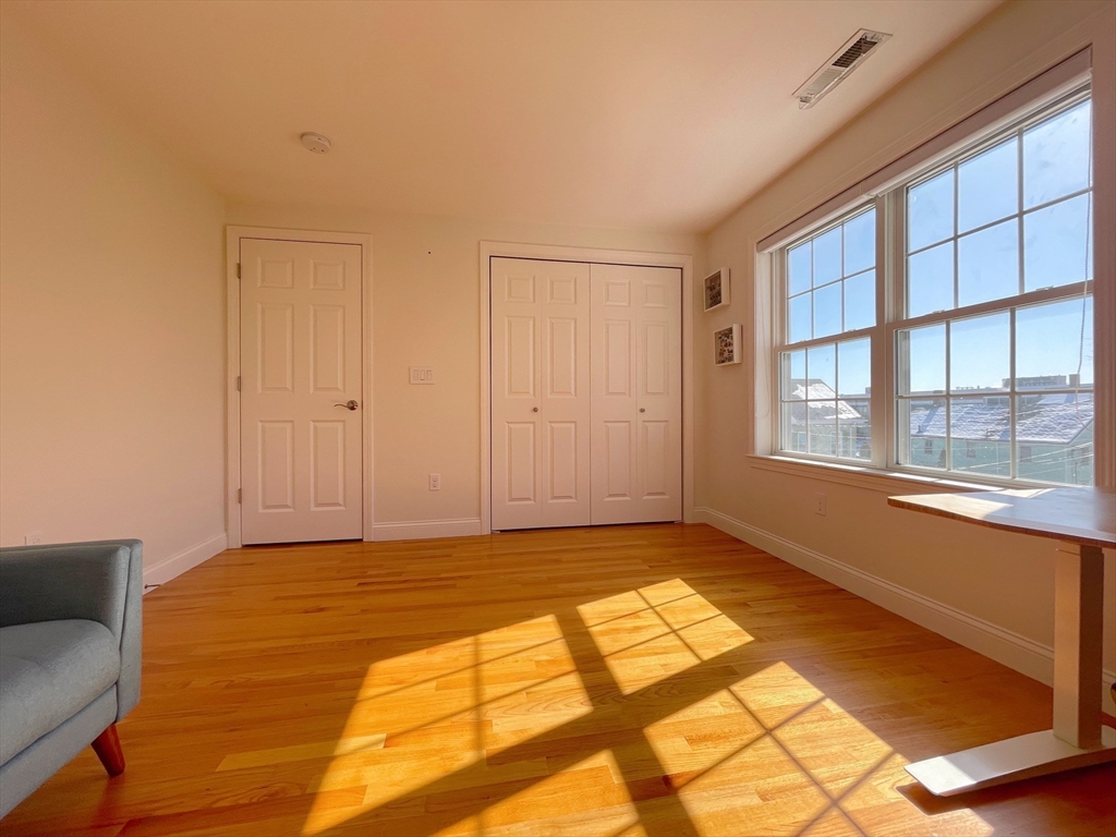 12 Naviens Lane, Unit 1 Waltham, MA 02453 - Photo 7 of 12 a view of an empty room and window