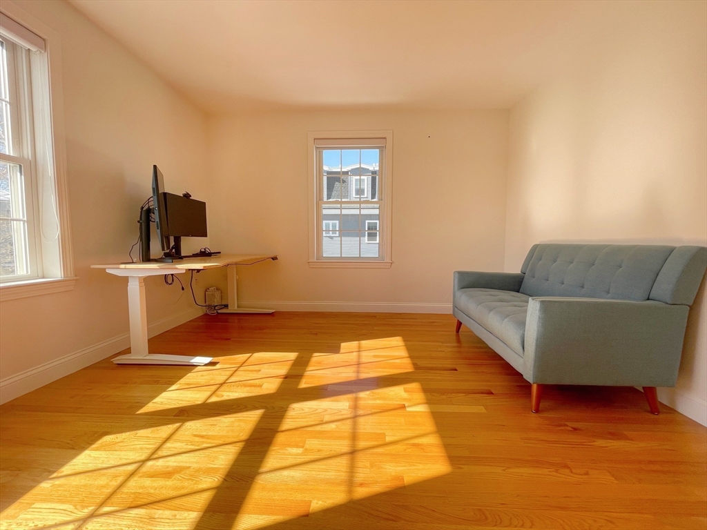 12 Naviens Lane, Unit 1 Waltham, MA 02453 - Photo 8 of 12 a living room with a couch and next to a window