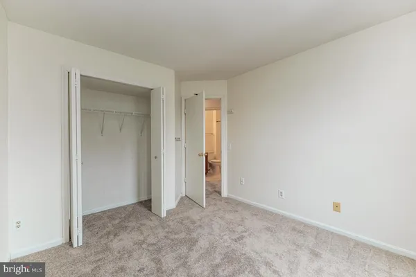 an empty room with closet area