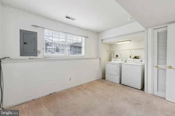 a utility room with cabinets washer and dryer
