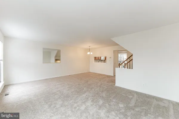 an empty room with windows and mirror