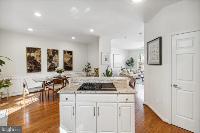 a kitchen with stainless steel appliances granite countertop a stove and white cabinets