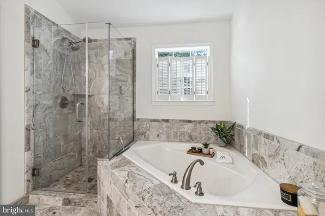 a bathroom with a bathtub and shower