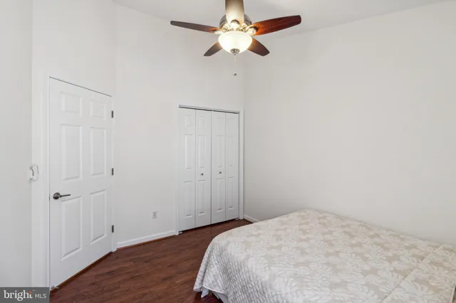 a bedroom with a bed and a ceiling fan