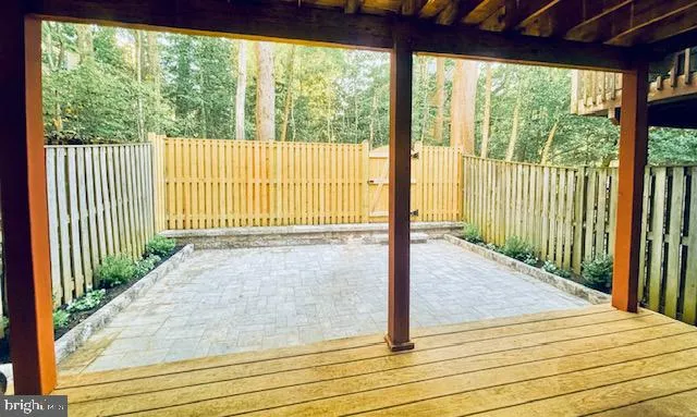 a view of a room with wooden floor and fence