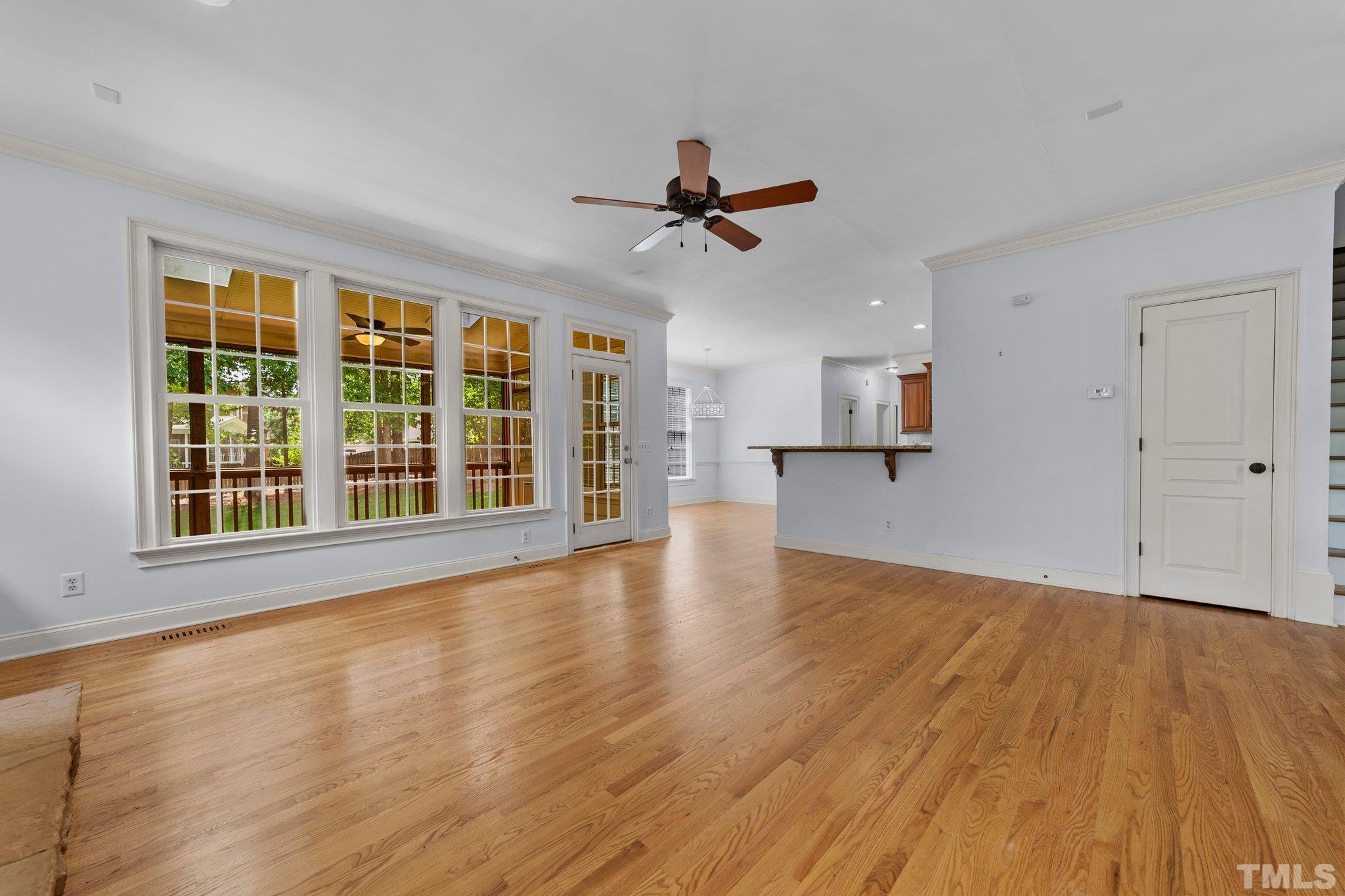 4012 Grandbridge Drive Apex, NC 27539 - Photo 22 of 51 a view of an empty room with a window and wooden floor